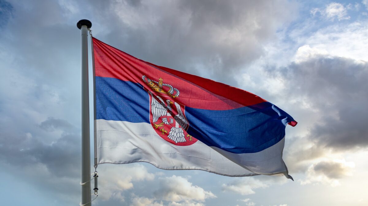 Serbia flag waving against cloudy sky