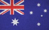 Australia flag depicted in bright paint colors on old relief plastering wall close up