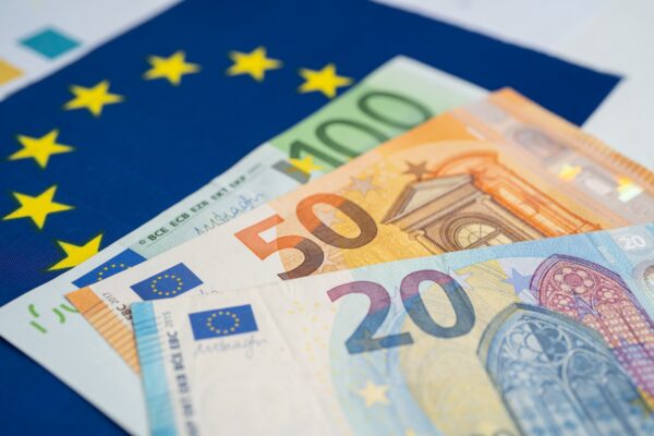 Euro banknote on EU flag.